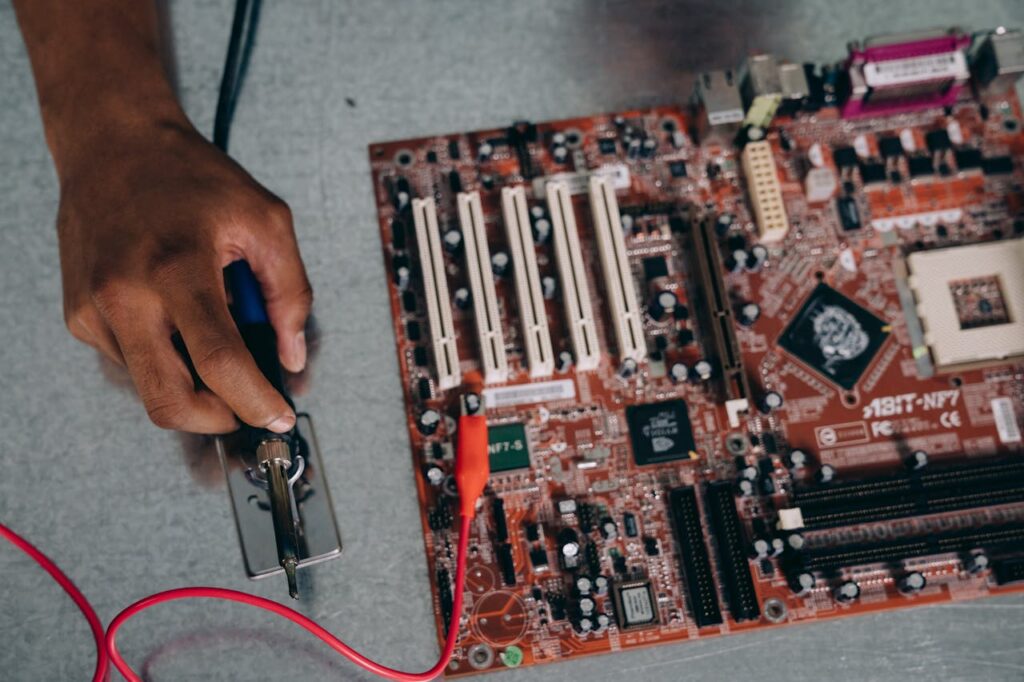 pexels photo 9242888 An engineer uses a soldering tool on a motherboard, showcasing technology and precision.